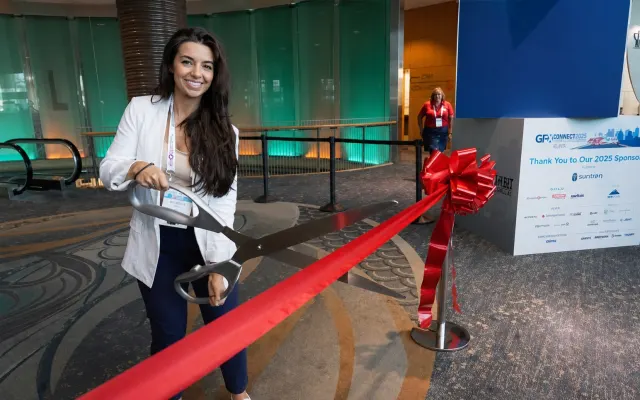 Nichole Osinski at GFX showcase floor ribbon cutting