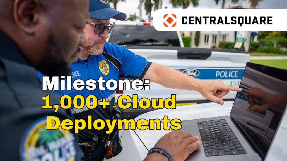 Two police officers working on a laptop computer, logo for CentralSquare, and headline Milestone: 1,000+ Cloud Deployments.