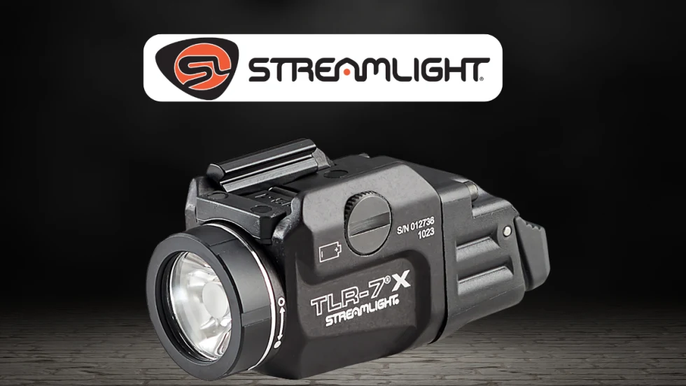 Product image of a Streamlight TLR-7 X tactical flashlight on a dark background. The compact black weapon-mounted light is shown in close-up beneath the Streamlight logo, highlighting its lens, controls, and mounting hardware.