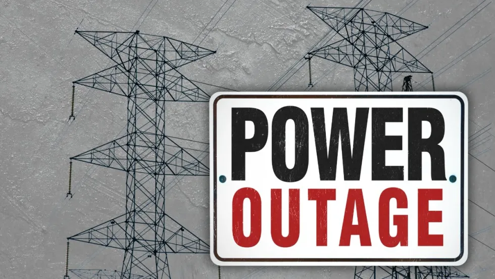 Power lines on a stormy day with the words POWER OUTAGE
