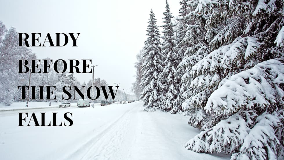 a winter road with snowy trees and cars