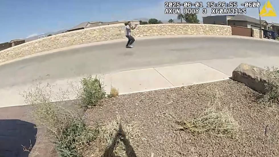 Body camera view of person walking on concrete path near stone wall on sunny day