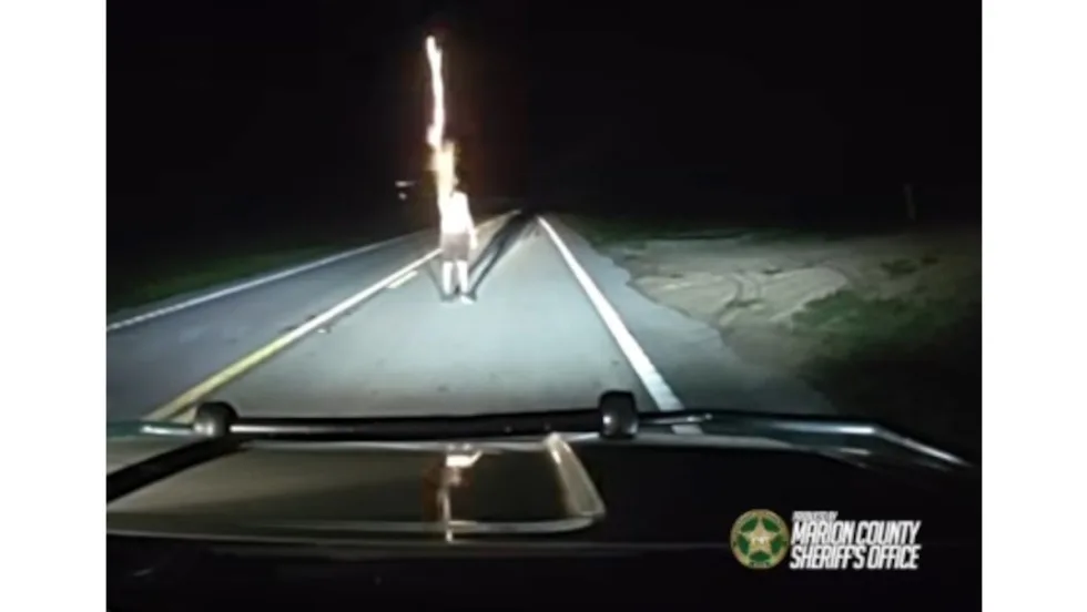 Nighttime dashboard view of police vehicle dashcam with road ahead