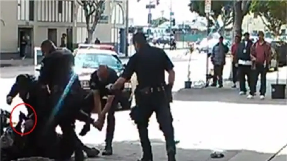 LAPD officers shot and killed a convicted bank robber Sunday after he reportedly tried to grab one of the the officers' guns.