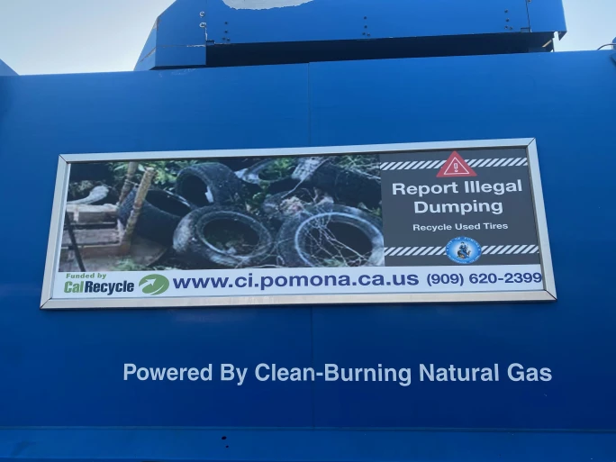 The side of a refuse truck.