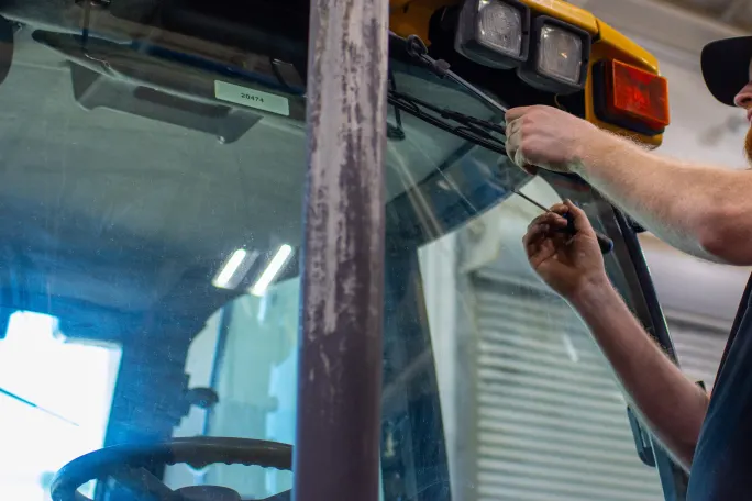 A man working on a schoolbus.