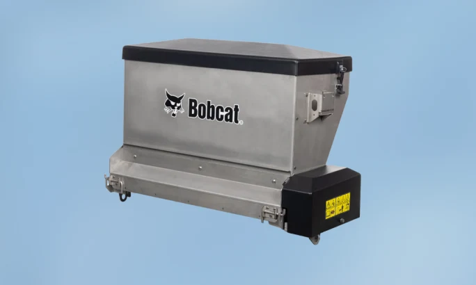 Bobcat drop spreader attachment for controlled distribution of salt, sand, or other materials.