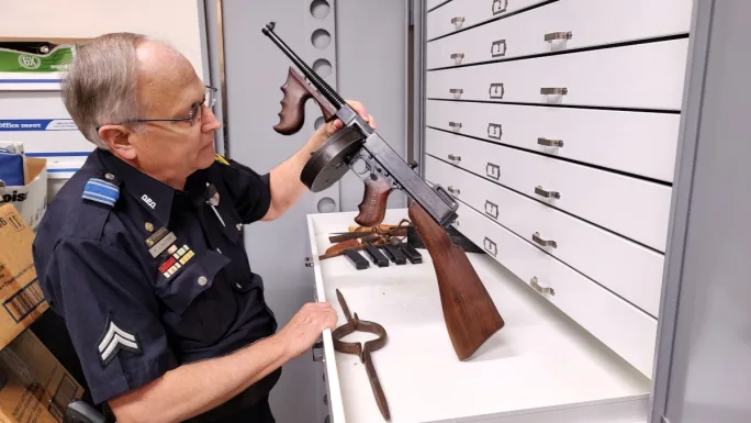 Senior Cpl. Paul Schuster shows the only Thompson submachine gun ever owned by the Dallas Police Department.[|CREDIT|]PHOTO: Wayne Parham