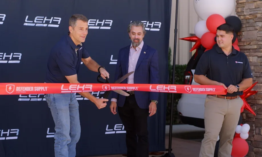 Three mean cut a ribbon.