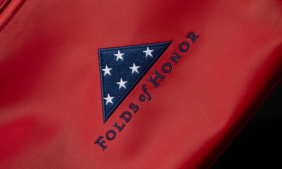 Red fabric background with blue and white Folds of Honor logo.