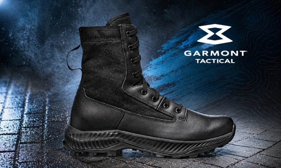 Black military style boot in leather against a blue and black cobblestone surface and a white logo for Garmont Tactical in upper right.