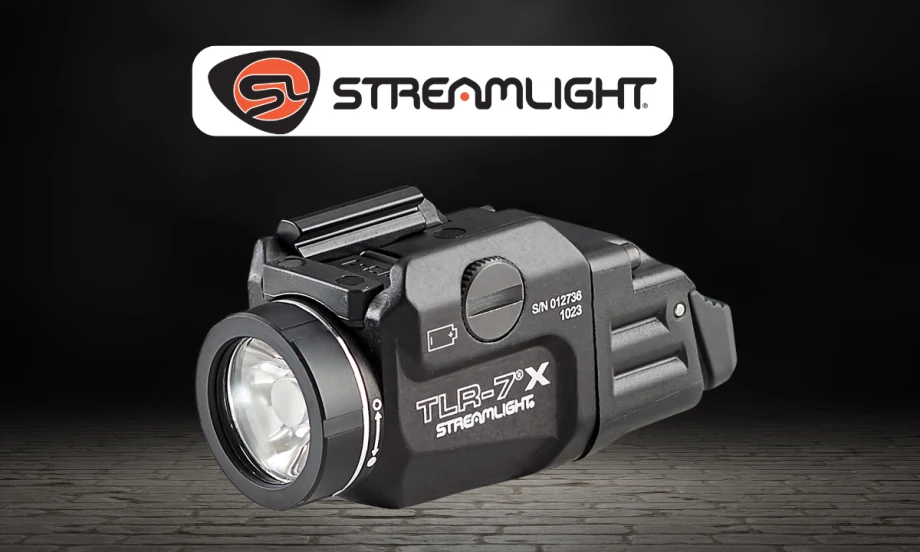 Product image of a Streamlight TLR-7 X tactical flashlight on a dark background. The compact black weapon-mounted light is shown in close-up beneath the Streamlight logo, highlighting its lens, controls, and mounting hardware.