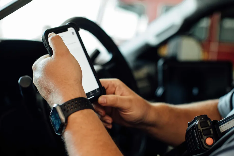 A man holding a phone in a truck.