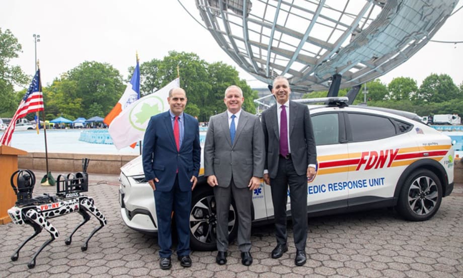 DCAS Deputy Commissioner Keith Kerman, FDNY Commissioner Robert S. Tucker, and DCAS Commissioner Louis A. Molina are standing in front of a new EV emergency medic response unit.
