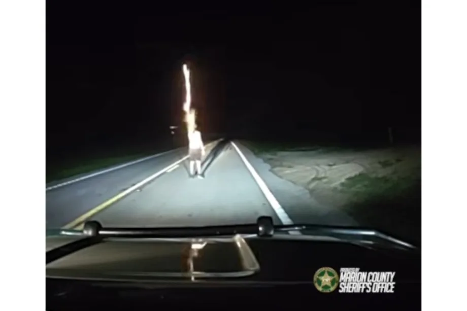 Nighttime dashboard view of police vehicle dashcam with road ahead