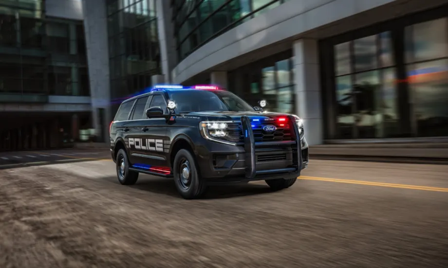 A black Ford Expedition SSV is shown driving down a city street.