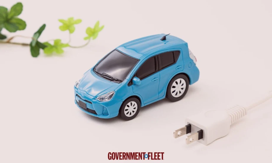 Small blue car with a green leaf and an electric plug.