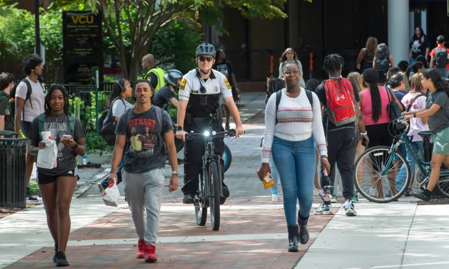 An officer rides an e-bike through the campus of Virginia Commonwealth University.