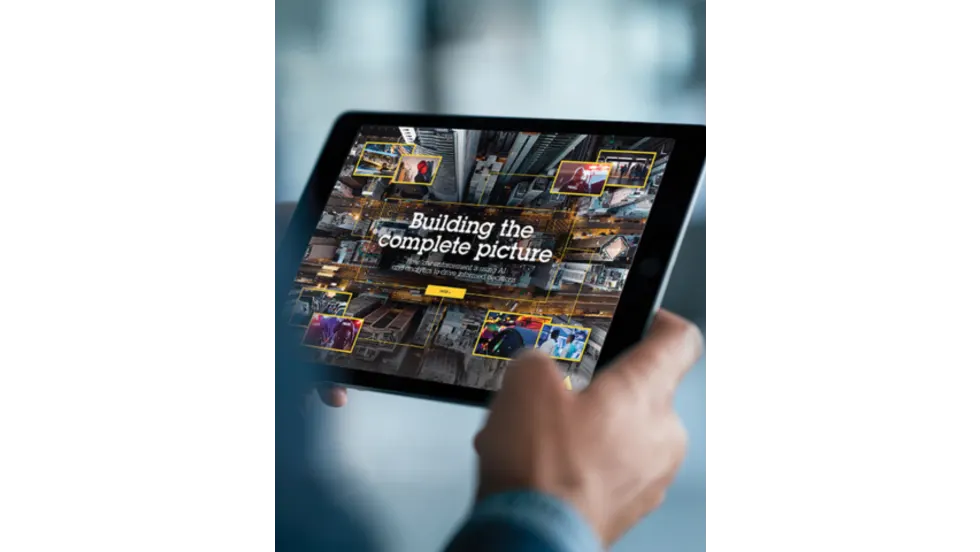 Person holding a tablet displaying a digital public safety technology interface