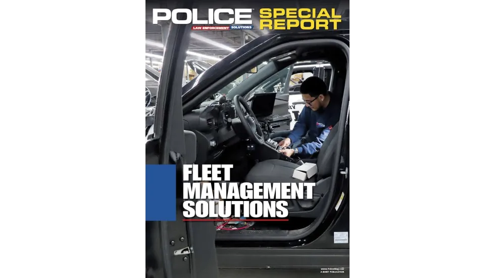 A technician installs equipment inside a black police vehicle in a garage or factory setting. The image is overlaid with the title text “Police Special Report: Fleet Management Solutions.”