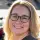 woman with glasses smiling