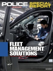 A technician installs equipment inside a black police vehicle in a garage or factory setting. The image is overlaid with the title text “Police Special Report: Fleet Management Solutions.”