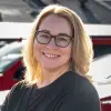 woman with glasses smiling